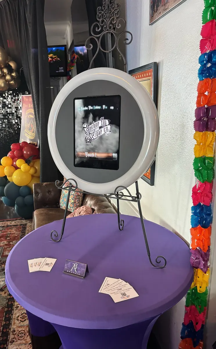 A3 Rentals ring-light booth on an easel showing a custom welcome screen above a purple table