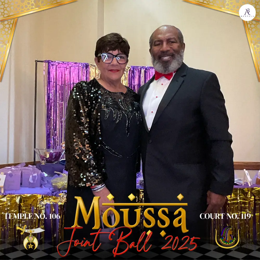 Couple in formal wear posing in a gold gala-style photo booth frame